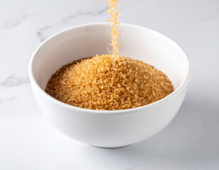 Brown sugar cascades into a bowl