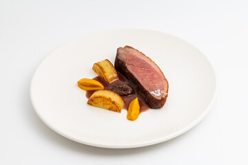 Gourmet roasted duck breast served with root vegetables and sauce