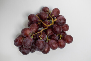 Ripe red grapes still on the stem, perfect for a healthy snack.