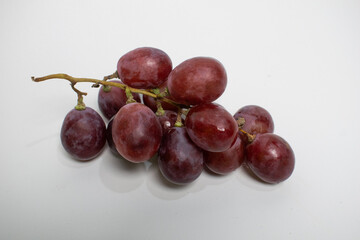 Juicy purple grapes with a glossy finish, captured in close-up.