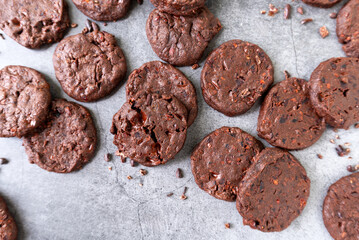 cacao nibs chocolate chunk cookies on grey background.