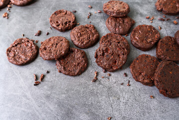cacao nibs chocolate chunk cookies on grey background.