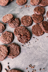 cacao nibs chocolate chunk cookies on grey background.