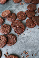 cacao nibs chocolate chunk cookies on grey background.