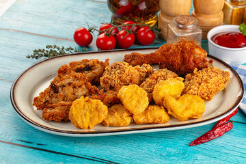 Golden crispy fried chicken mix - wings, drumsticks, nuggets and strips