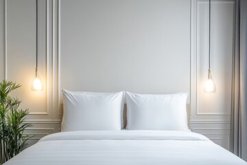 Luxurious white bedroom featuring pendant lights, crisp linens, and classic wall moldings, creating a serene atmosphere