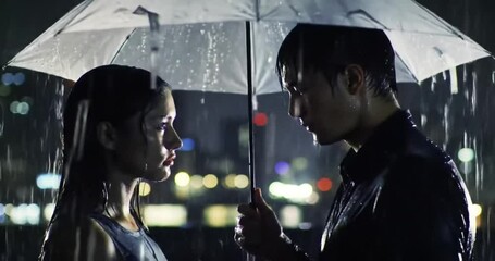 A loving couple finds shelter under an umbrella, sharing an intimate gaze on a rainy night with city lights as a backdrop.
