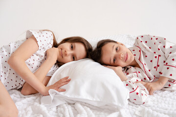Pajama party. Happy children's laughter. Happy girls laughing, lying next to each other. Concept of childhood, leisure, friendship. happiness. Cheerful good morning!