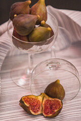 Juicy figs in a ceramic bowl on a wooden table - still life with natural light
