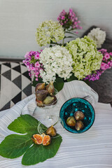 Juicy figs in a ceramic bowl on a wooden table - still life with natural light