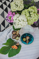 Juicy figs in a ceramic bowl on a wooden table - still life with natural light