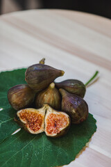 Juicy figs in a ceramic bowl on a wooden table - still life with natural light