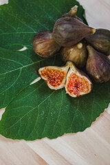 Juicy figs in a ceramic bowl on a wooden table - still life with natural light