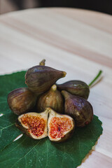 Juicy figs in a ceramic bowl on a wooden table - still life with natural light