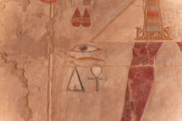 Eye of horus, ankh and triangle painted on ancient egyptian wall representing divinity and...