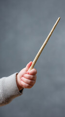Baby Hand Holding a Light-Colored Magical Wand