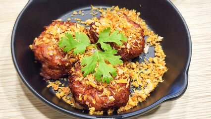 Fried pork hamburger is arranged on a wooden table.