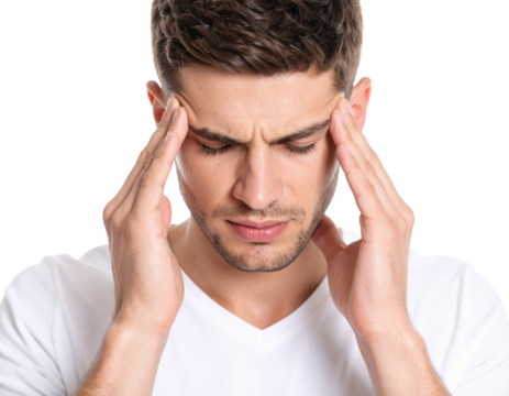 A young man in a white shirt holds his temples, displaying signs of headache or stress against a black background.