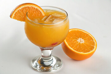 Orange juice with ice cubes and a slice of orange isolated on white background