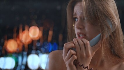 Worried Woman Speaking Nervously on Phone at Night