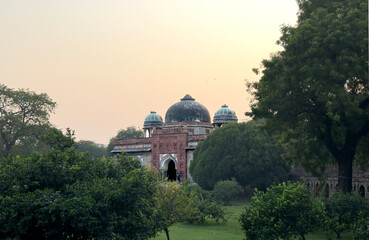 View of the Tomb of Muhammad Shah at sunset in Lodhi Gardens, New Delhi, surrounded by lush green