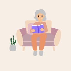 Happy elder woman reading a book on sofa.