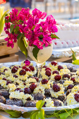 Cherry Desserts with Cream and Pink Flowers in Elegant Glass Luxury Catering Setup