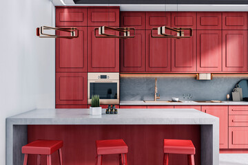 Modern red kitchen interior with wooden cabinets, concrete island, and stylish pendant lamps in a...
