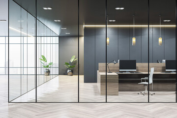 Modern corporate office interior with glass partitions, dark wall panels, wood desks, and a...