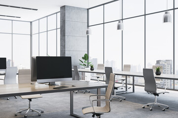 Modern empty office interior with panoramic city view, sleek furniture, and computer desks in...