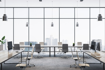 Modern spacious office interior with panoramic city skyline view through large glass windows and...