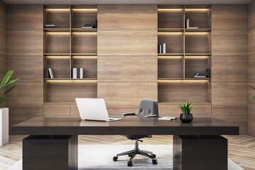 Modern executive office interior with wooden wall, sleek desk, laptop, and bookshelves in stylish...