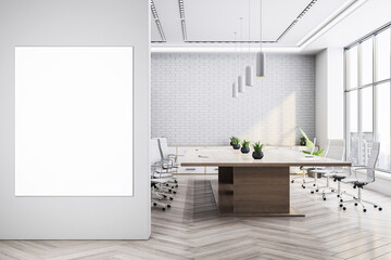 Modern empty boardroom interior with vertical white canvas mockup and wooden meeting table in...
