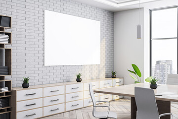 Modern conference room interior with white brick wall, large blank canvas mockup, stylish desk, and...