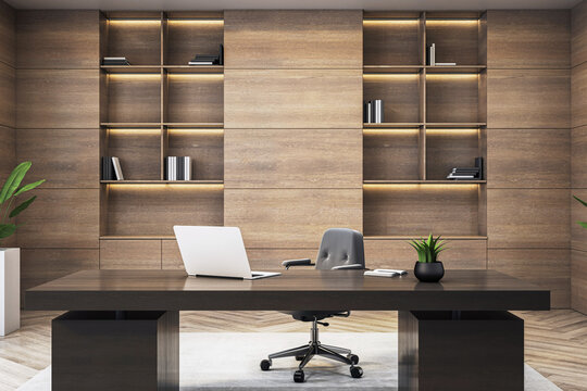 Modern executive office interior with wooden wall, sleek desk, laptop, and bookshelves in stylish corporate workspace setting. 3D Rendering