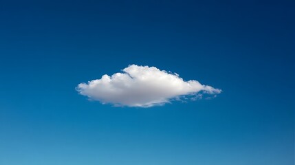A solitary cloud floating in the bright blue sky