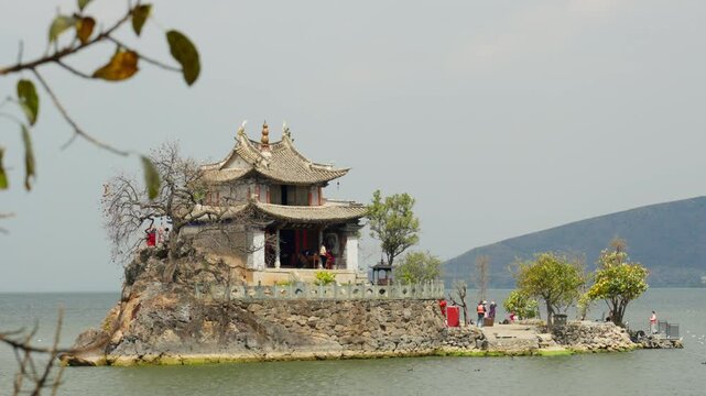 A traditional temple Xiao Pu Tuo with intricate architecture nestled beside Erhai Lake. A stunning example of cultural heritage in Yunnan, China.