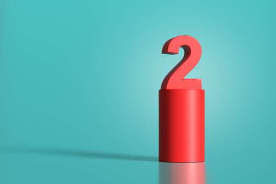 Red number two standing on red cylinder on turquoise background