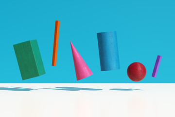 Colorful geometric shapes floating on blue background with soft shadows