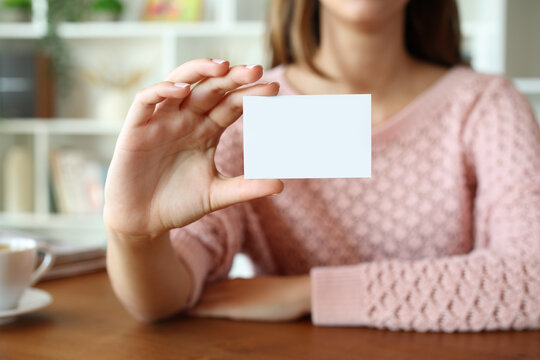 Woman hand showing blank identity card at home