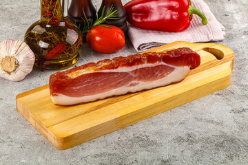 Piece prosciutto crudo over board