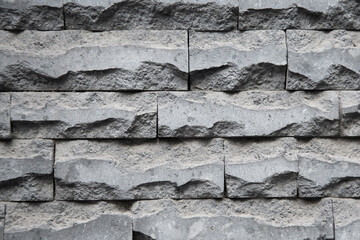 A detailed closeup image showcasing a brick wall composed of gray bricks