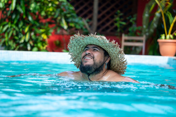 Tourist enjoying his vacation , relaxing by the pool in Tortuguero, Costa Rica