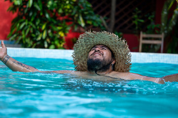 Tourist enjoying his vacation , relaxing by the pool in Tortuguero, Costa Rica