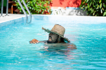 Tourist enjoying his vacation , relaxing by the pool in Tortuguero, Costa Rica