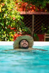 Happy local tourist enjoying the tropical weather at a swimming pool in Tortuguero, Costa Rica