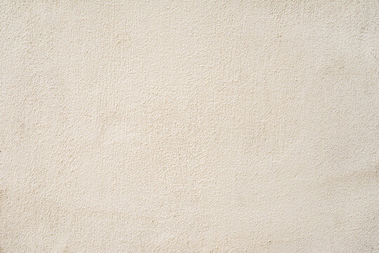Beige plastered wall texture background. Plain light beige wall with soft plaster texture, minimal surface relief. Concept of simplicity, neutrality, architectural natural background
