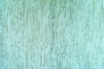 Vintage light green, pastel background of plastered wall. Textured teal wall with vertical relief...