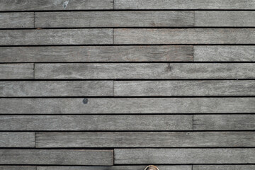 
A flat lay captures the weathered texture of horizontal wooden planks, creating a uniform...