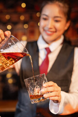 Professional female bartender preparing alcoholic drinks in a bar